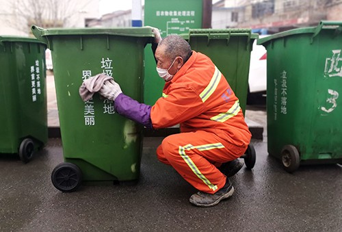 2月24日,安徽省界首市界光路三巷,环卫工人在擦洗垃圾桶