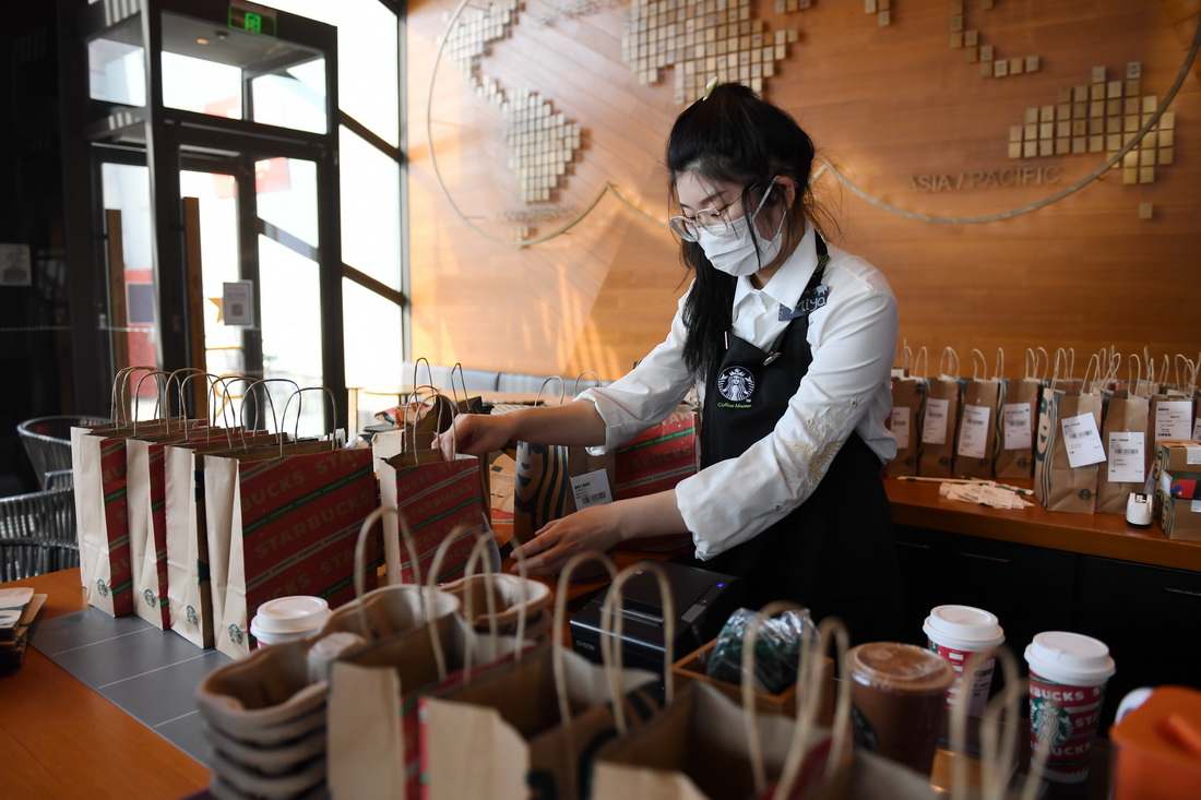 1月13日，在西安市一家连锁咖啡店，店员整理外送的咖啡饮品。
