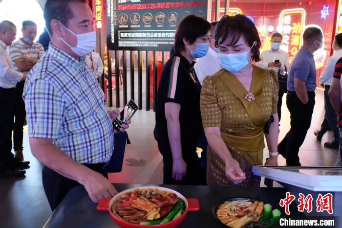 多国侨商在广西探访当地著名小吃螺蛳粉