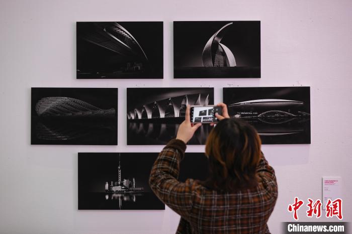 “中国第18届国际摄影艺术展览巡展贵州站”展厅作品“海上华章”吸引参观者拍摄。　瞿宏伦 摄