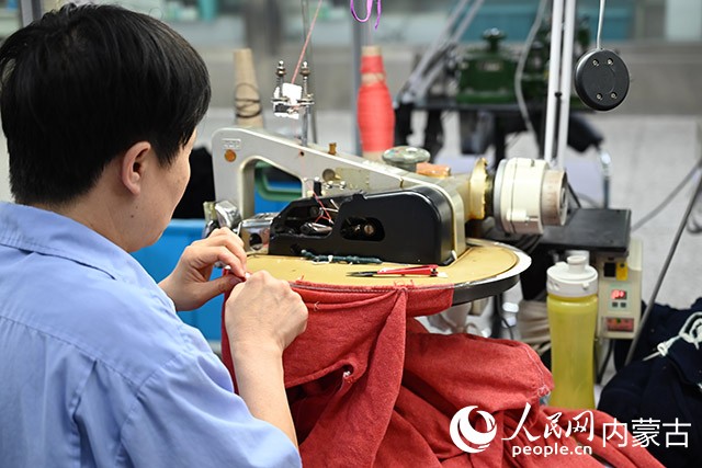 针织厂工人正在做合身工作。 人民网 寇雅楠摄