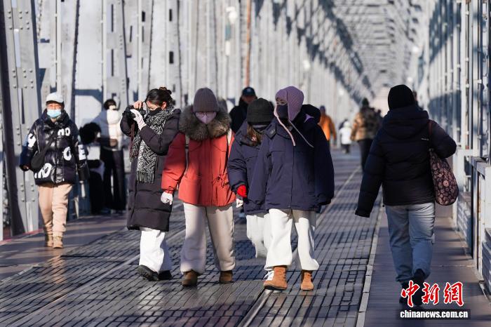 黑龙江哈尔滨气温持续走低 市民添衣出行
